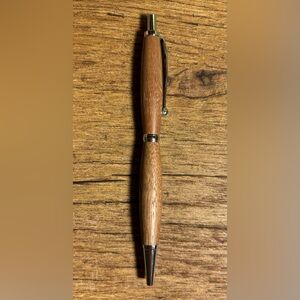 Beautiful Hand turned wood ink pen. Smooth writing black ink. Silver accents.